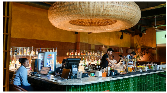 Hospitality bar team working behind a modern counter